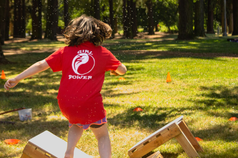 A student competing in our 2022 Kung Fu in the Park promotion obstacle course