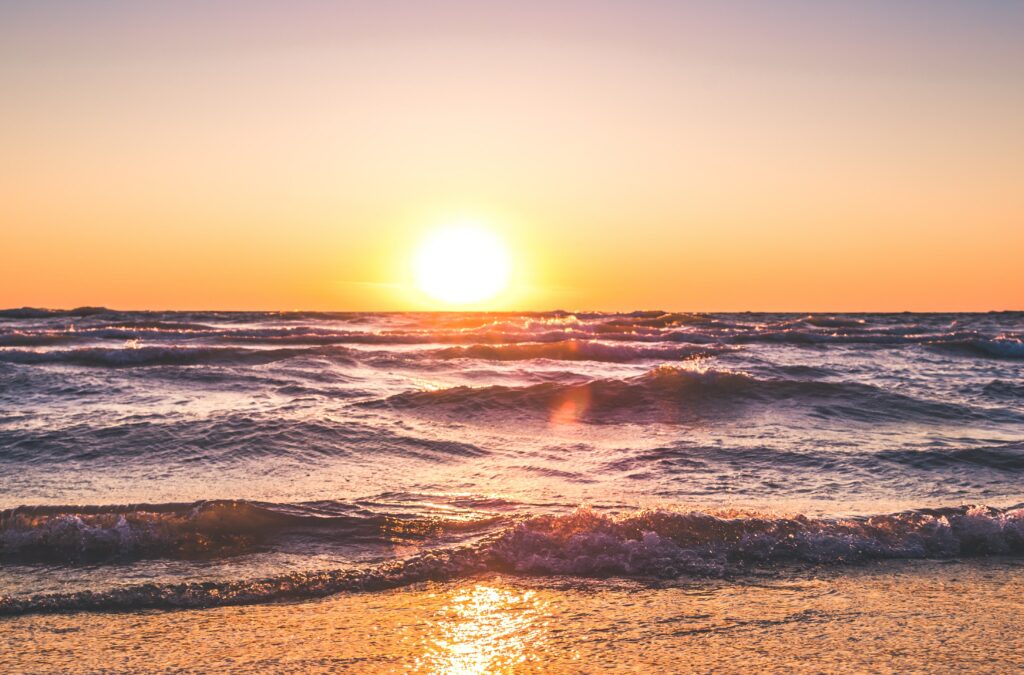 An image of a beach at sunset